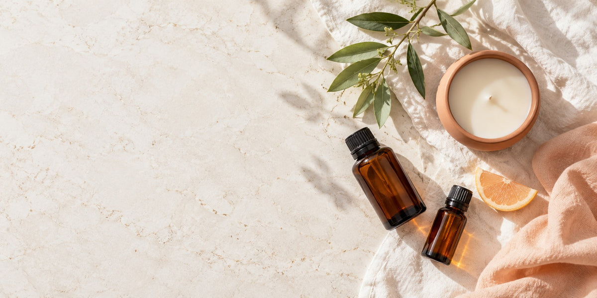 A morning care ritual with amber bottles, a candle, leaves and soft linen